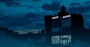 A dramatic cityscape at dusk with a police station silhouette and bright blue sky, highlighting law enforcement.