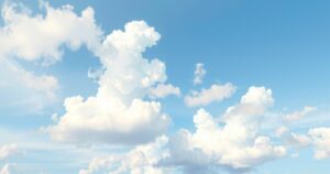 Partly cloudy sky with soft hues of blue and white, representing a serene weekend weather forecast.