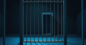 An abstract representation of law enforcement with dark tones, depicting a capsule of a prisoner in prison bars.