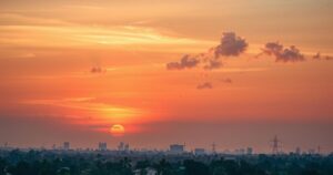 A serene landscape with a sunset over Abuja, Nigeria, symbolizing remembrance and honor, in warm, soothing colors.