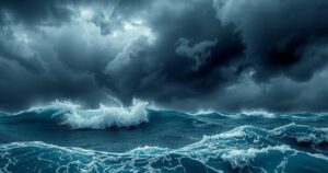 A turbulent ocean with dark storm clouds looming above, showcasing the impact of a powerful cyclone on a tropical island.